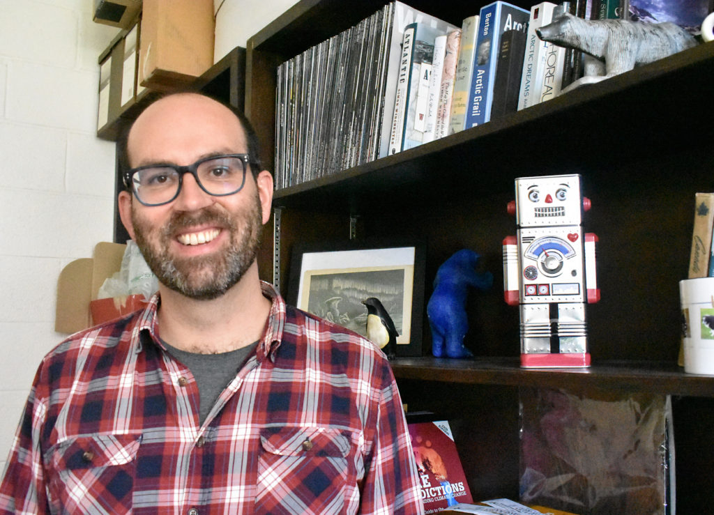 Joel Finnis is an associate professor in the Department of Geography. He is in his office with the robot piggy bank that his sister gave him for his birthday.Melissa Wong/Kicker