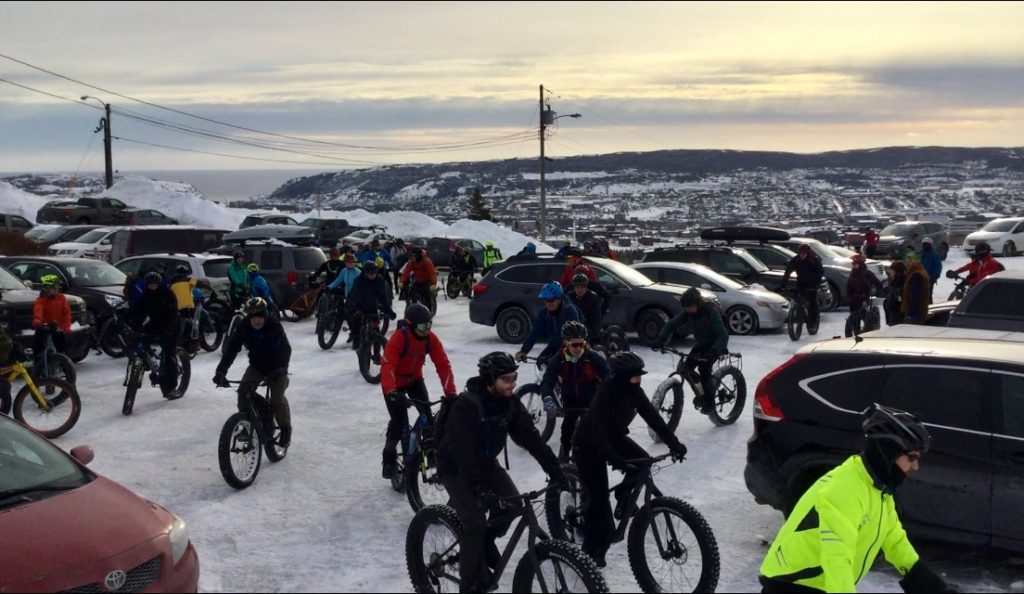 The 2019 Pippy Snowbike Festival’s bikers prepare to leave the Admirals Green Golf Course Club House’s parking lot. The bikers steer their fat bikes toward the freshly groomed bike course through the snow. 