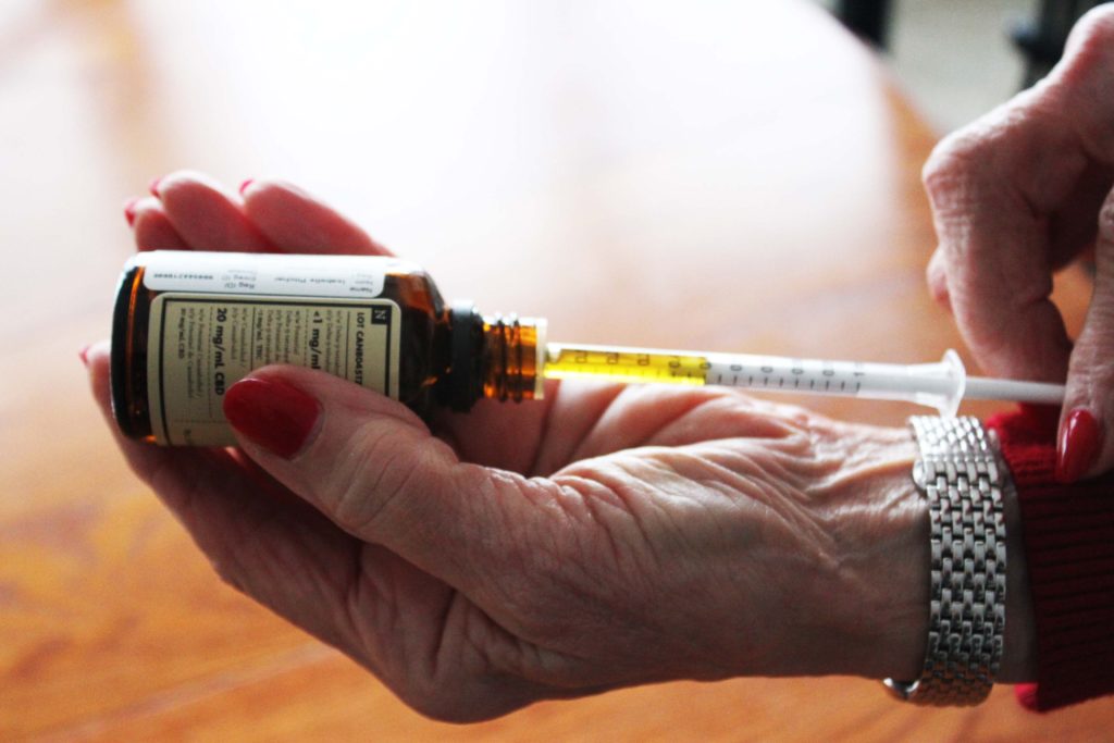 Mickie Pitcher, 77, of St. John's draws her regular dose of CBD oil with a syringe. Pitcher began taking CBD oil last year after experiencing the frightening symptoms of opiate withdrawal. Many seniors are turning to cannabis as a safer alternative to medications that include opiates.