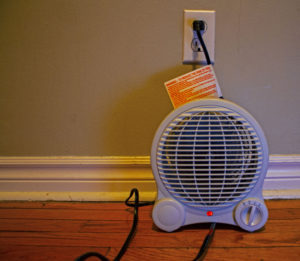 A space heater and manufacturer's instructions. Firefighters urge caution when using secondary heat sources