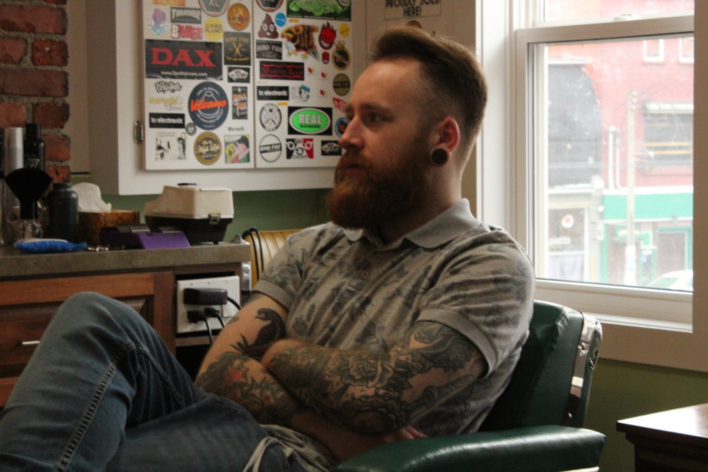 Jeremy Edgar waits for the workday to begin at his barbershop in downtown St. John's. Edgar is among the volunteers who provide free haircuts to needy people in St. John's.
