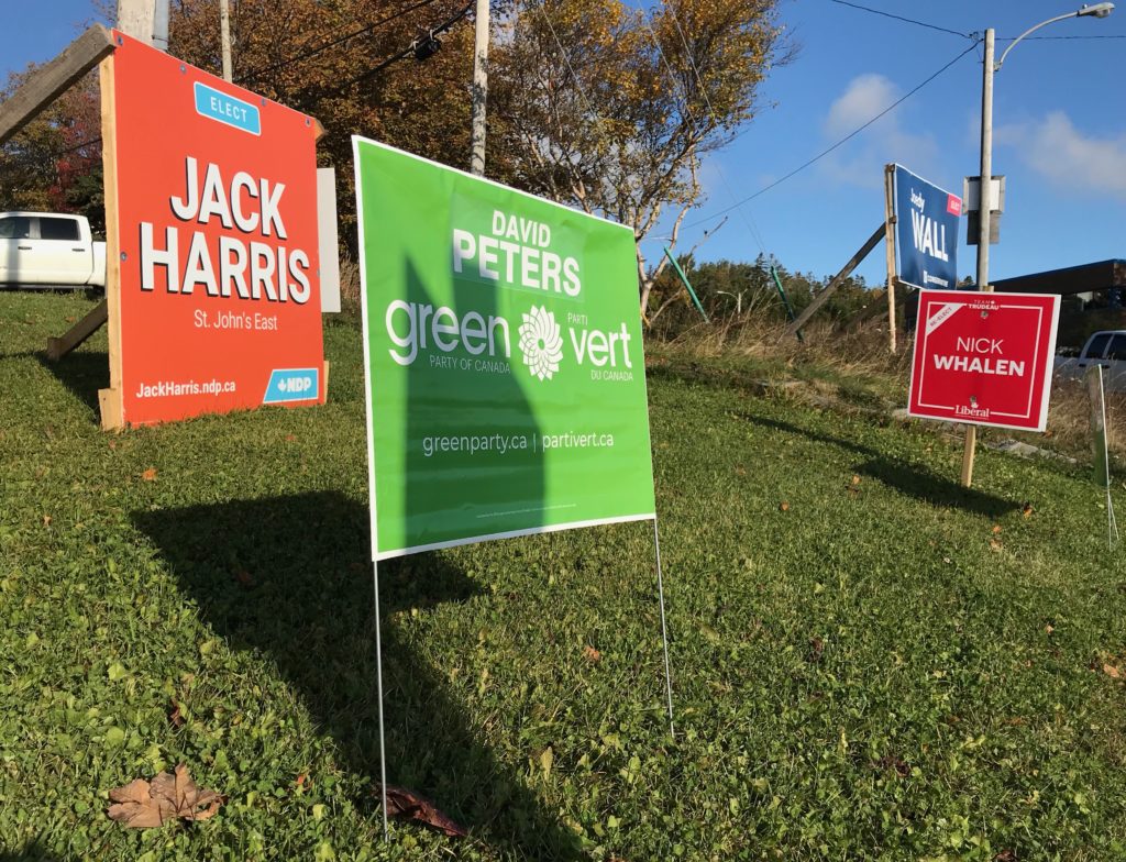 Signs with each political candidates name on the on Portugal Cove Road.