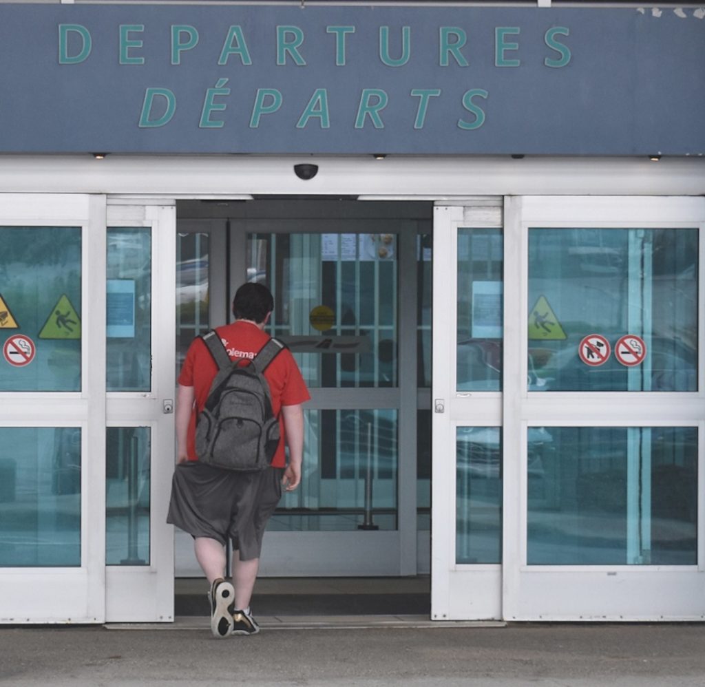 Person walking through departure gate at St. John's Airport