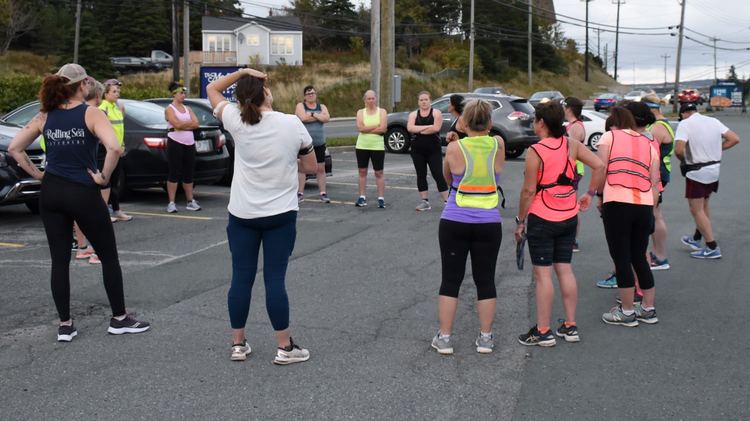 A group of runners from Sister's in Fitness stretch and prepare for a run. Most are training for the Cape to Cabot virtual race.