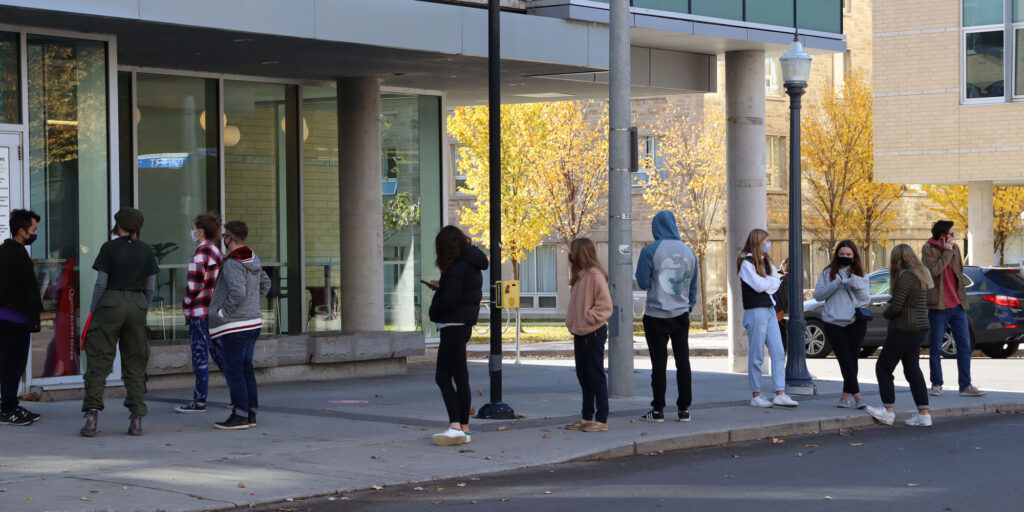 Photo depicts a group of Queen's students waiting in line to get lunch on Saturday Oct. 31st.