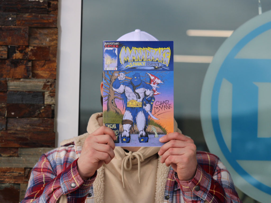 Outside of Timemasters' comic book store, a customer holds a copy of Byrne's comic up. 
