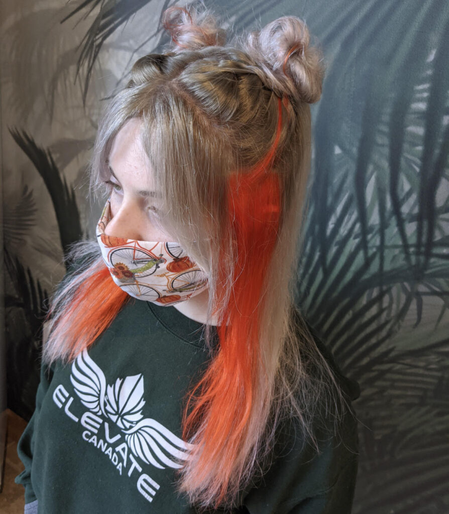  A client of hairstylist Emma Whitt poses while wearing a face mask.
