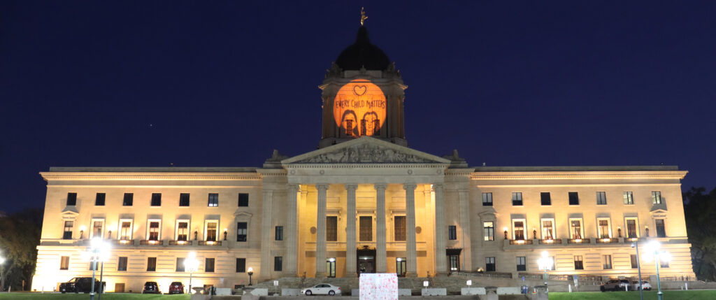 Winnipeg legislature building with every child matters projected on top