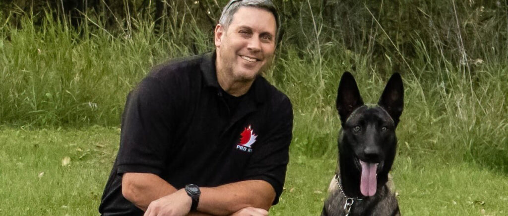 Duane Hutt poses with Sparta, the Belgian Malinois