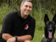 Duane Hutt poses with Sparta, the Belgian Malinois