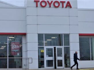 A person walks out the front door of Toyota Plaza in St. John's, NL.