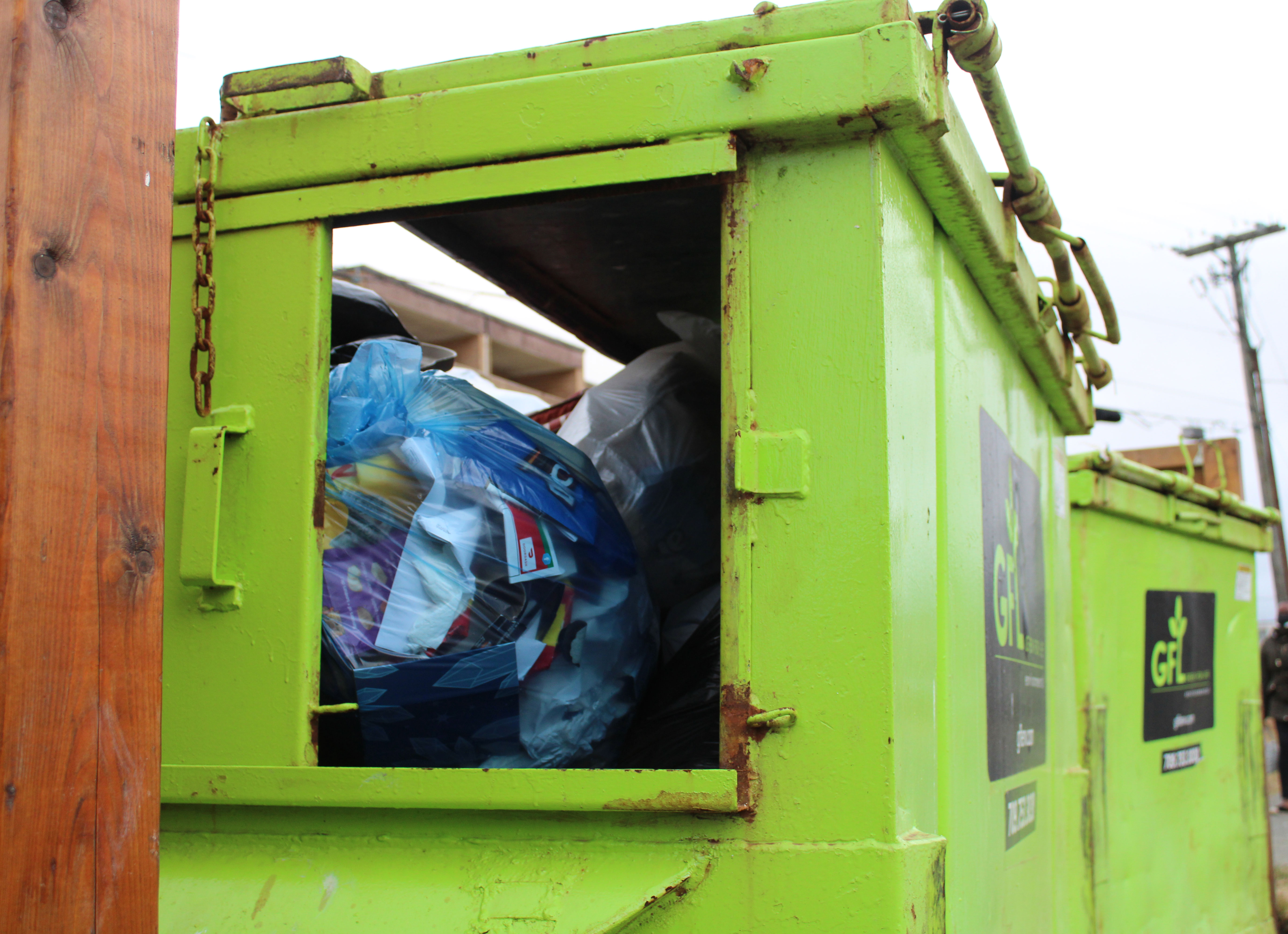 Two green GFL (Green For Life) garbage collector bins are in the parking lot near Green Depot Recycling on Elizabeth Avenue. It contains household paper, plastic and metal items which contribute to 37 per cent of waste in the province.
