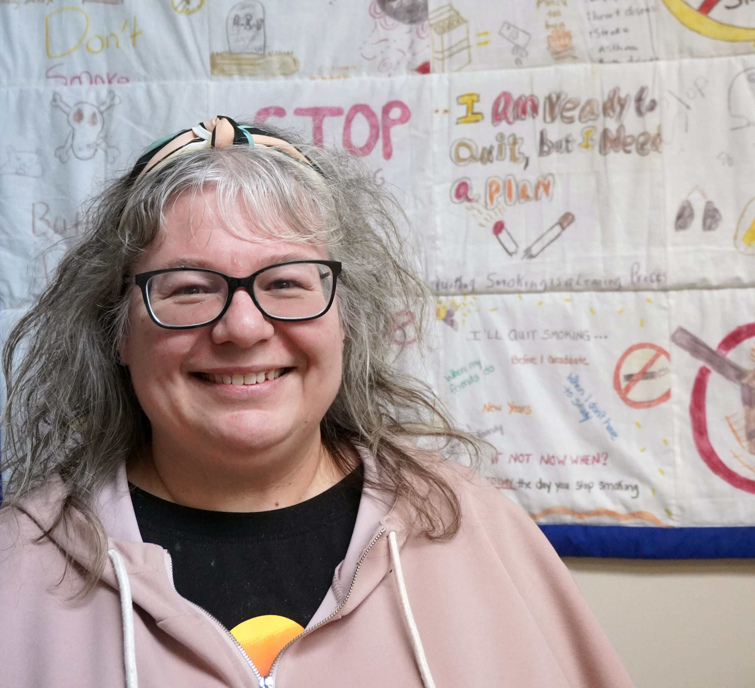 Melissa Moore is the program and education coordinator at The Newfoundland and Labrador Alliance for the Control of Tobacco. Standing in front of a stop smoking whiteboard made by kids with a big smile on her face, addressing the concern of the increasing vape rate among young people,