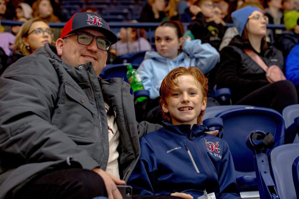 Ben Higdon, a 10-year-old Growlers fan who was hit by a puck later in the evening, is enjoying a night out with his dad