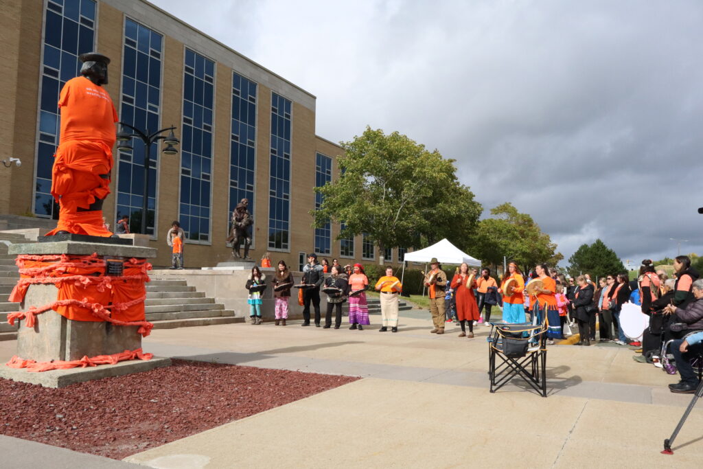 Image shows people gathered around John Cabot's statue.