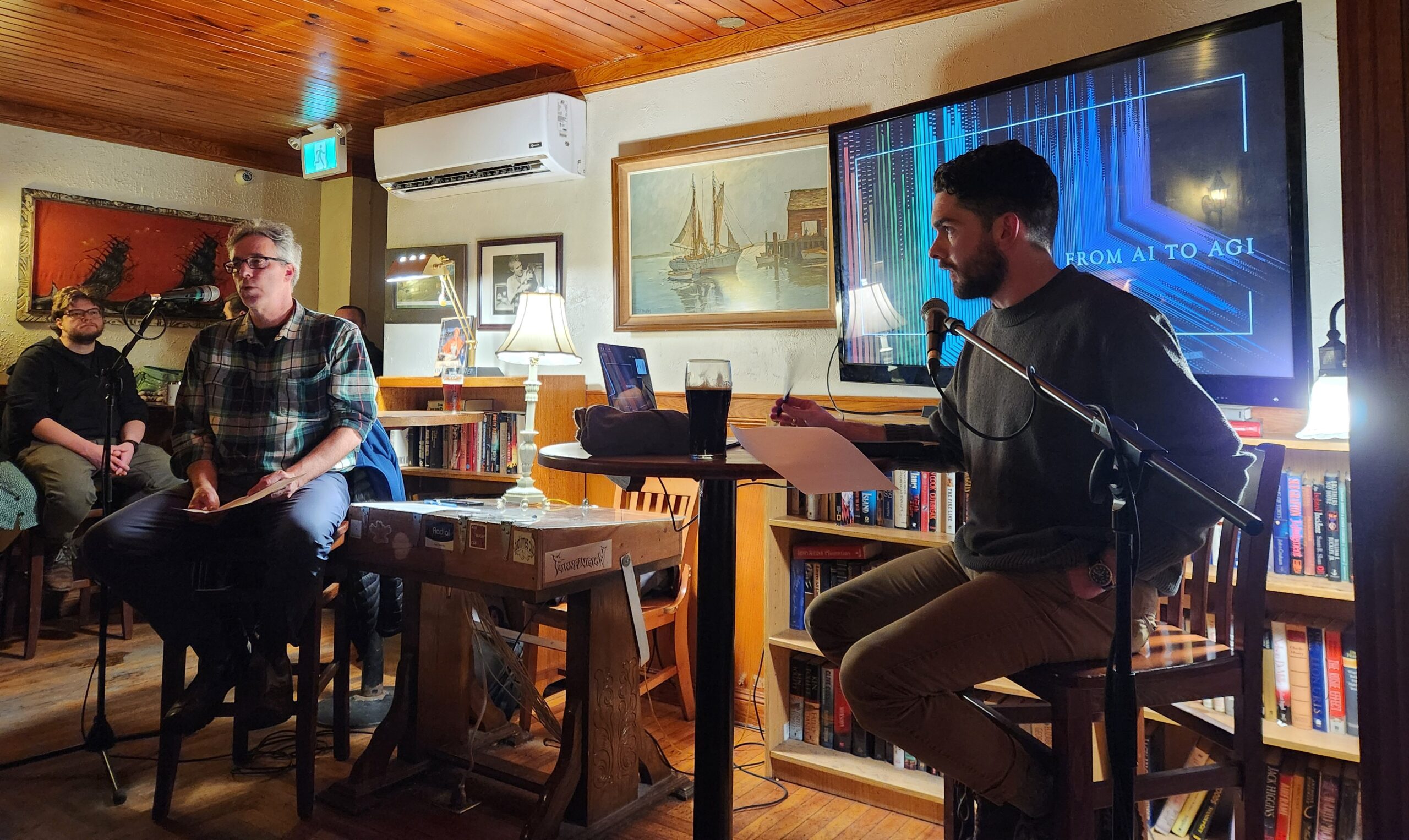 Ethics professor Arthur Sullivan and provincial government A.I. expert Dylan White of Memorial University prepare for their public lecture about artificial general intelligence at the Peter Easton Pub.