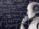 A robot touches his hand to his chin as if in deep thought in front of a blackboard marked with complex formulas. Perhaps he is wondering when artificial general intelligence will become a reality.