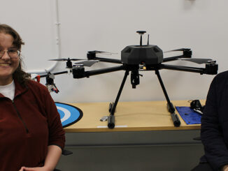Spencer Field (left) and Mohammad Awad pose with drones developed by their team, Valiant Aerotech, at Memorial University