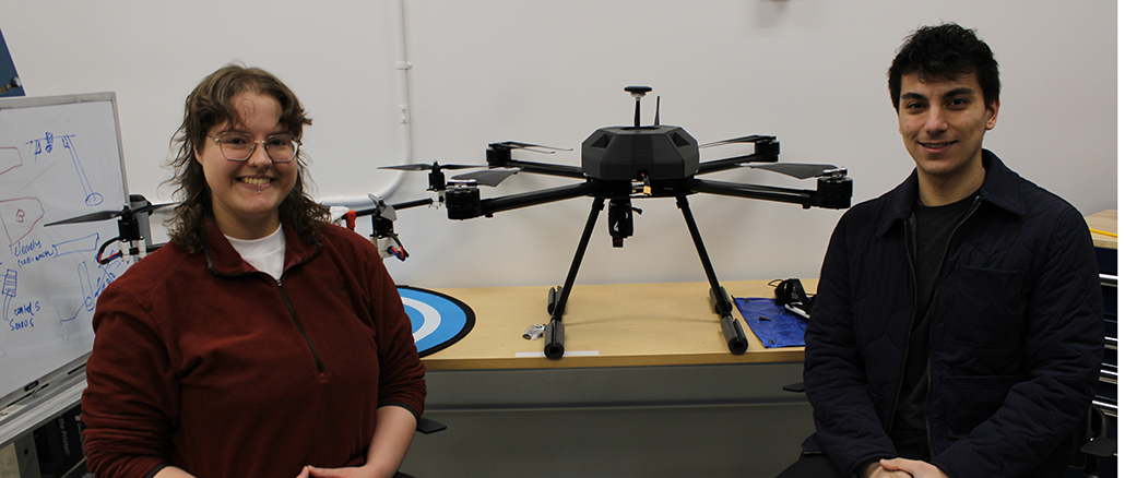 Spencer Field (left) and Mohammad Awad pose with drones developed by their team, Valiant Aerotech, at Memorial University