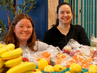 Leah Vatcher and Charlotte Leese sit at the Food On The Move pop-up at College of the North Atlantic's Prince Phillip Drive campus.