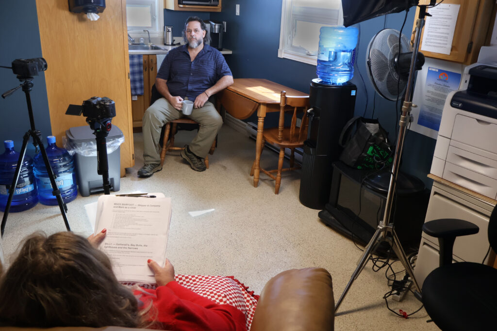 Pam Pardy, bottom left, interviews Fort Amherst lighthouse keeper Billy Ryan inside the lighthouse keeper’s quarters for the documentary The Music Takes Me Back.