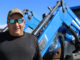 Tom Williams stands in front of his tractor